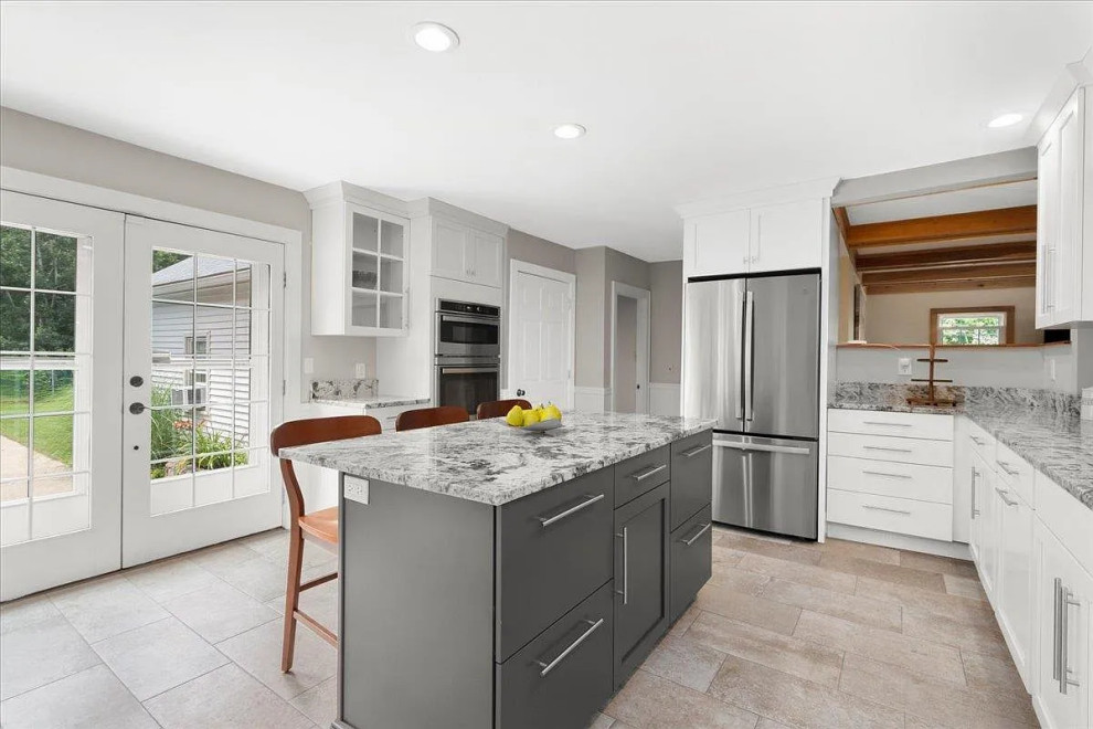 Example of a large transitional u-shaped enclosed kitchen design in Boston with an undermount sink, shaker cabinets, white cabinets, granite countertops, stainless steel appliances, an island and gray countertops
