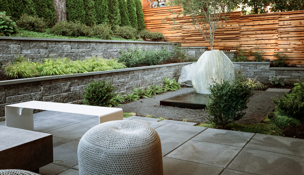 Inspiration for a mid-sized modern full sun backyard concrete paver landscaping in Seattle.