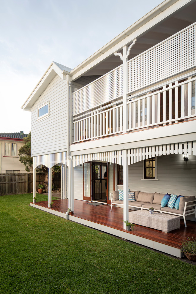 Inspiration for a beach style backyard verandah in Brisbane with decking and a roof extension.