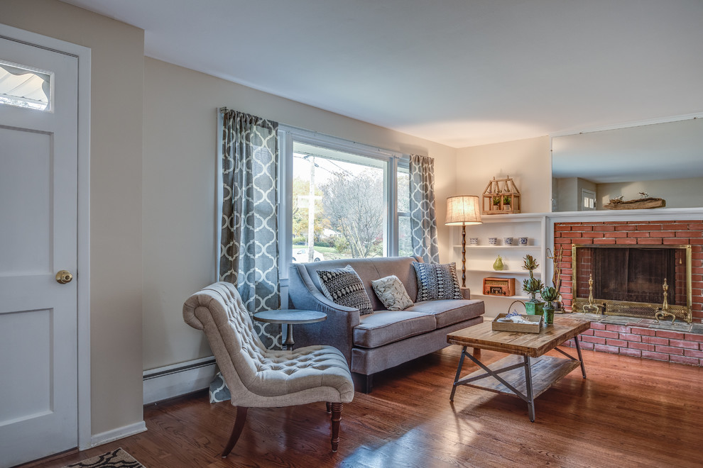 Inspiration for a traditional formal open concept living room in Bridgeport with grey walls, dark hardwood floors, a standard fireplace, a brick fireplace surround and brown floor.
