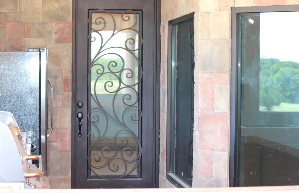 Photo of a mediterranean front door in Dallas with a single front door and a metal front door.