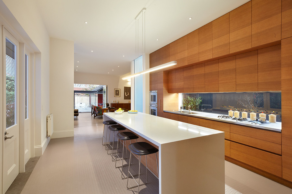 Photo of a contemporary kitchen in Melbourne with flat-panel cabinets, medium wood cabinets and with island.