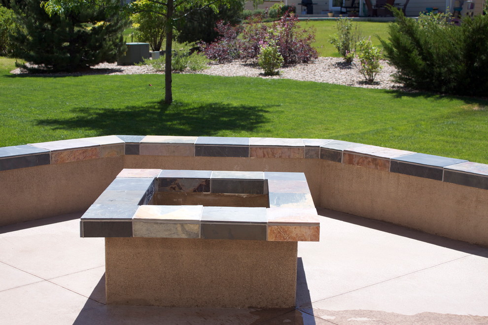 Inspiration for a large contemporary backyard patio in Denver with a fire feature, stamped concrete and no cover.