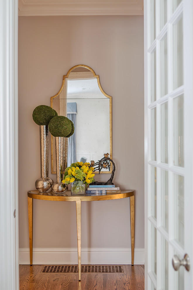 Front door - small transitional medium tone wood floor and brown floor front door idea with beige walls and a white front door
