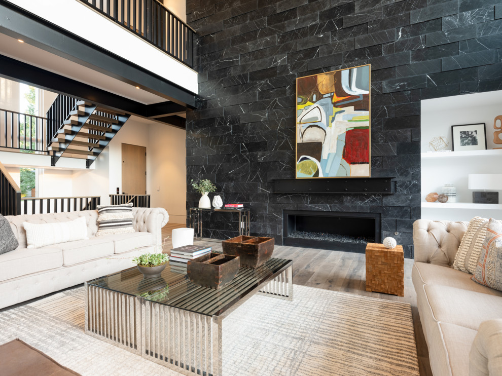 Photo of a large contemporary open concept living room in Denver with white walls, medium hardwood floors, a standard fireplace and a stone fireplace surround.