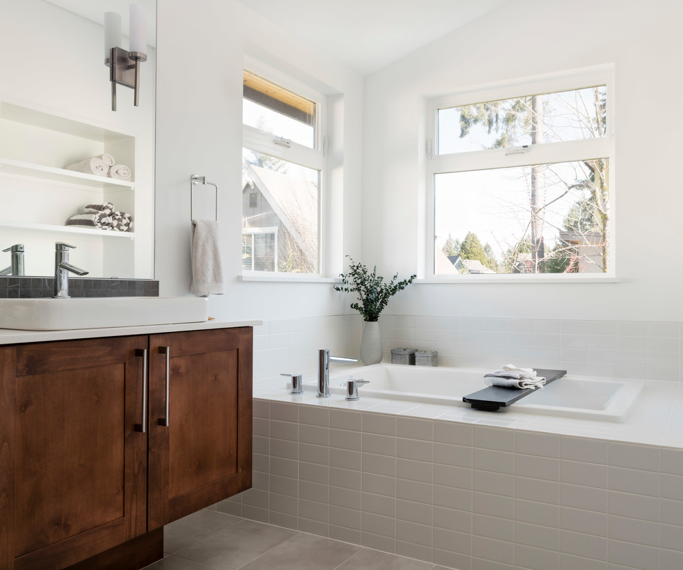 Design ideas for a large scandinavian master bathroom in Seattle with shaker cabinets, a drop-in tub, an open shower, a one-piece toilet, white tile, cement tile, white walls, ceramic floors, a vessel sink, engineered quartz benchtops, grey floor, a hinged shower door, white benchtops and dark wood cabinets.