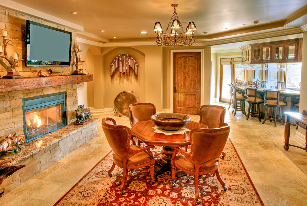 Photo of a traditional dining room in Indianapolis with beige walls, travertine floors and a stone fireplace surround.