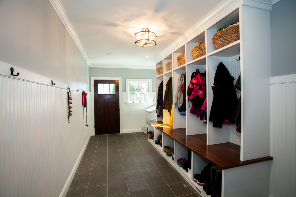 Mid-sized traditional mudroom in Philadelphia with blue walls, slate floors, a single front door and a dark wood front door.