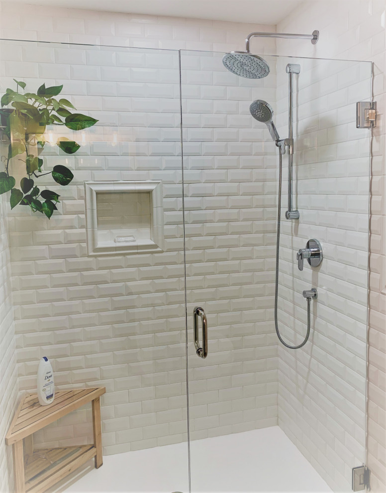 Photo of a medium sized beach style ensuite bathroom in Other with a built-in bath, a corner shower, a one-piece toilet, white tiles, metro tiles, yellow walls, a hinged door and a freestanding vanity unit.