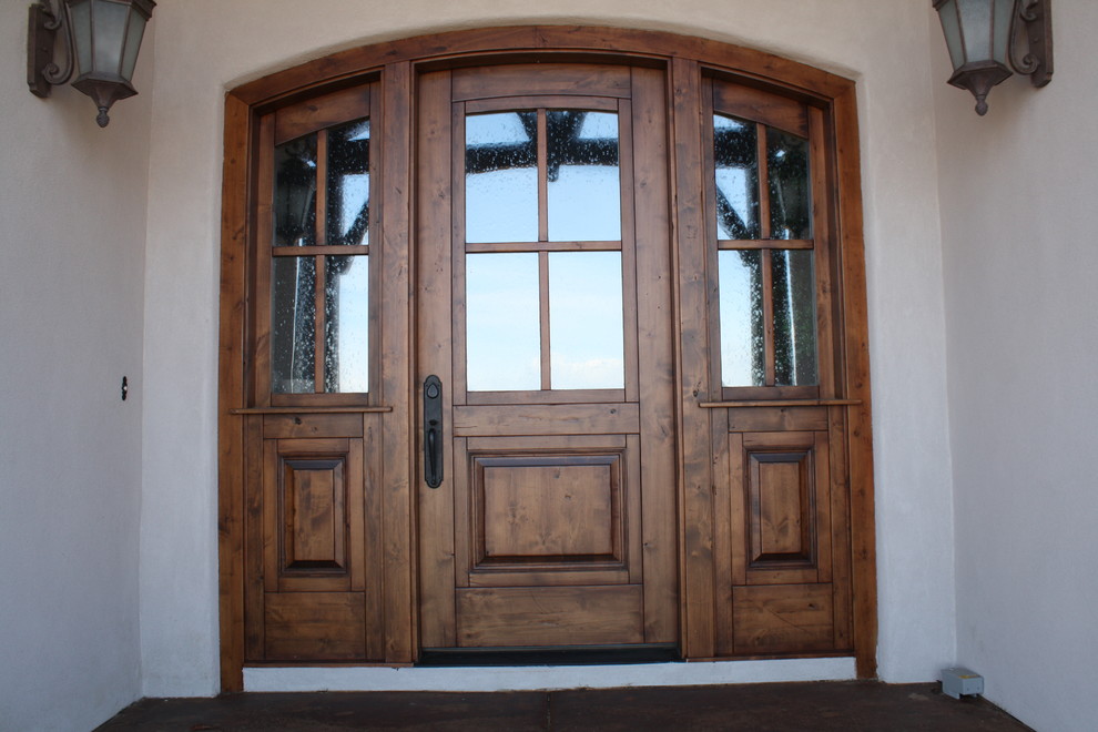 Front door - large modern front door idea in Denver with white walls and a dark wood front door