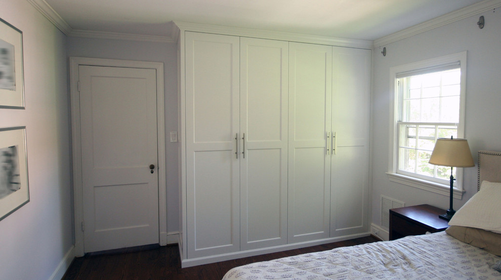 This is an example of a modern built-in wardrobe in DC Metro with recessed-panel cabinets and white cabinets.