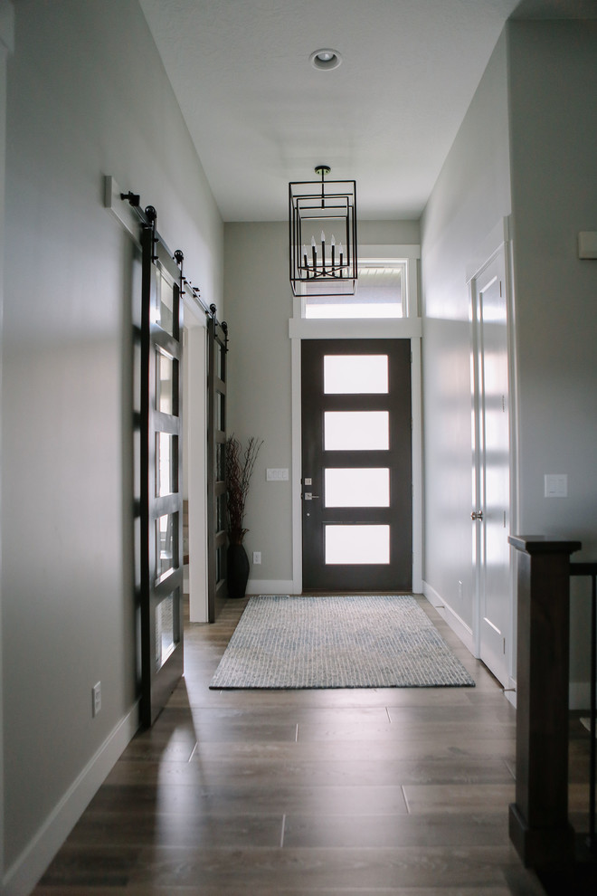 Design ideas for a mid-sized transitional front door in Salt Lake City with grey walls, porcelain floors, a single front door, a glass front door and brown floor.