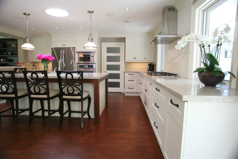 Large transitional l-shaped dark wood floor and brown floor eat-in kitchen photo in Toronto with an undermount sink, shaker cabinets, white cabinets, stainless steel appliances and an island