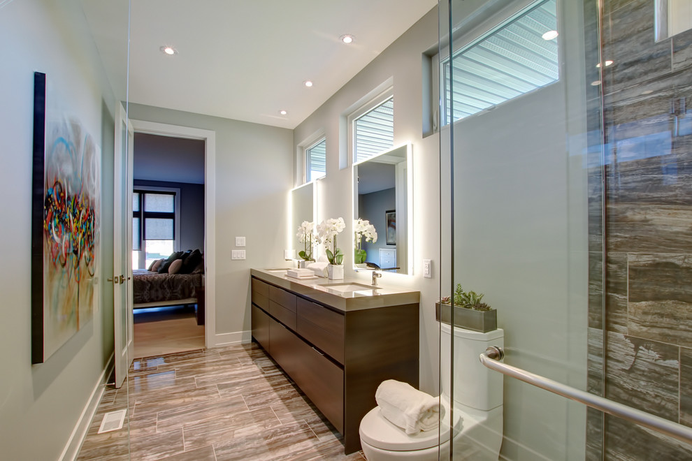 Photo of a mid-sized contemporary 3/4 bathroom in Toronto with flat-panel cabinets, dark wood cabinets, an alcove shower, a one-piece toilet, brown tile, porcelain tile, brown walls, porcelain floors, an undermount sink, quartzite benchtops, brown floor, a hinged shower door and beige benchtops.