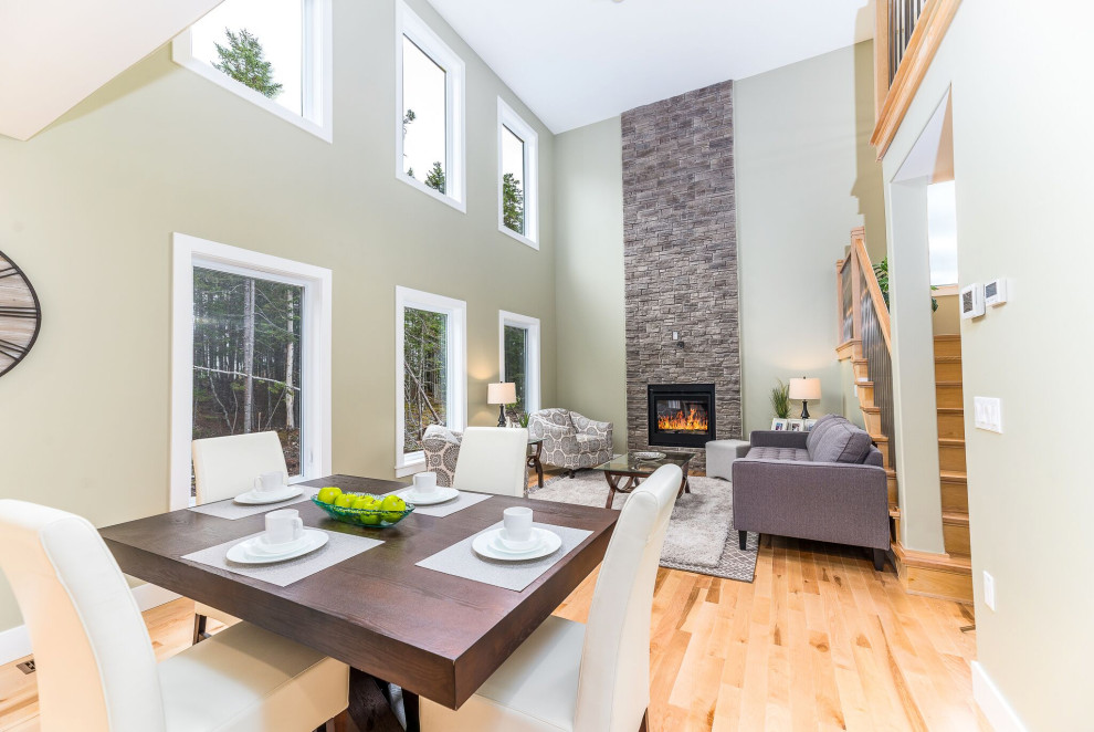 Mid-sized contemporary open concept living room in Other with light hardwood floors, a standard fireplace, a stone fireplace surround and beige floor.