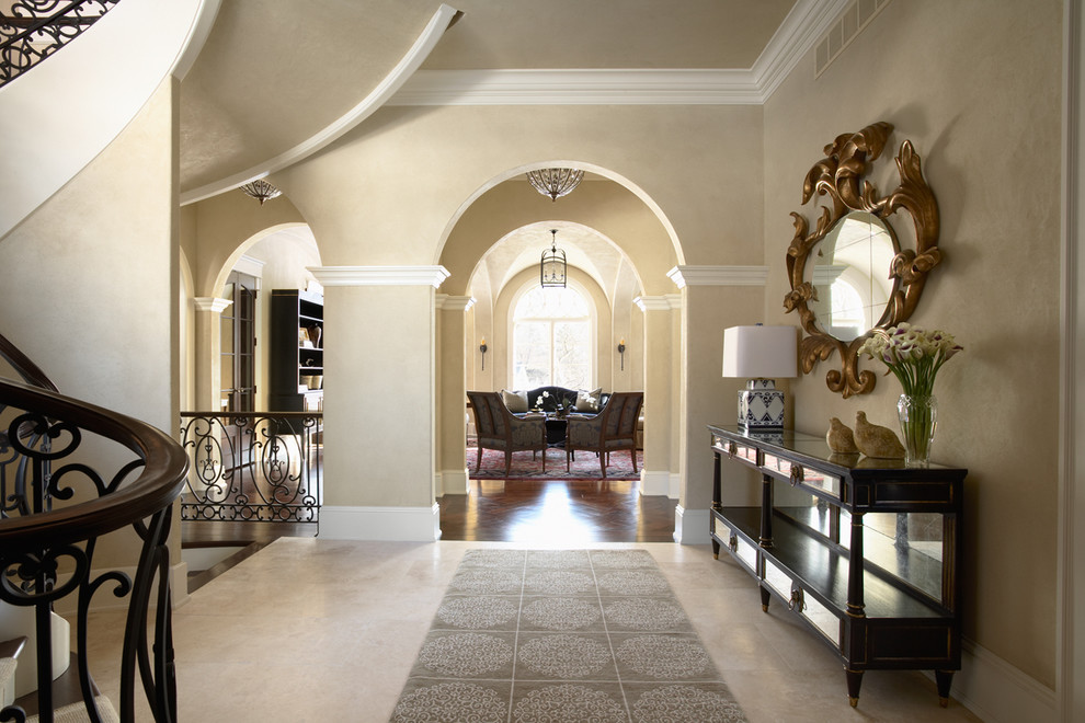 This is an example of a large traditional foyer in Minneapolis with beige walls and grey floor.