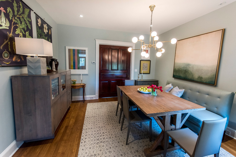 This is an example of a mid-sized transitional separate dining room in DC Metro with blue walls, medium hardwood floors and brown floor.