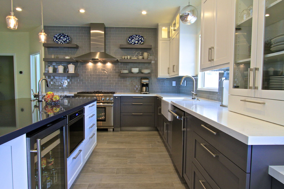 Inspiration for a transitional porcelain tile kitchen remodel in Orange County with glass tile backsplash and an island