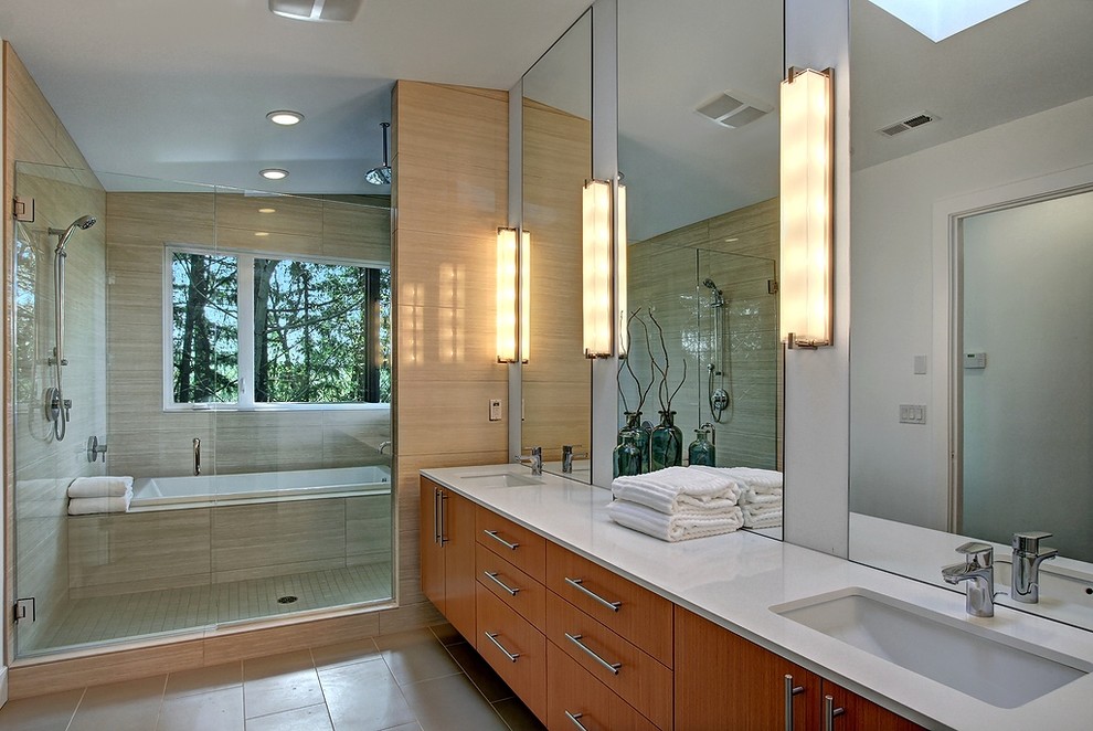 This is an example of a contemporary master bathroom in Seattle with flat-panel cabinets, medium wood cabinets, a drop-in tub, a shower/bathtub combo, beige tile and white walls.