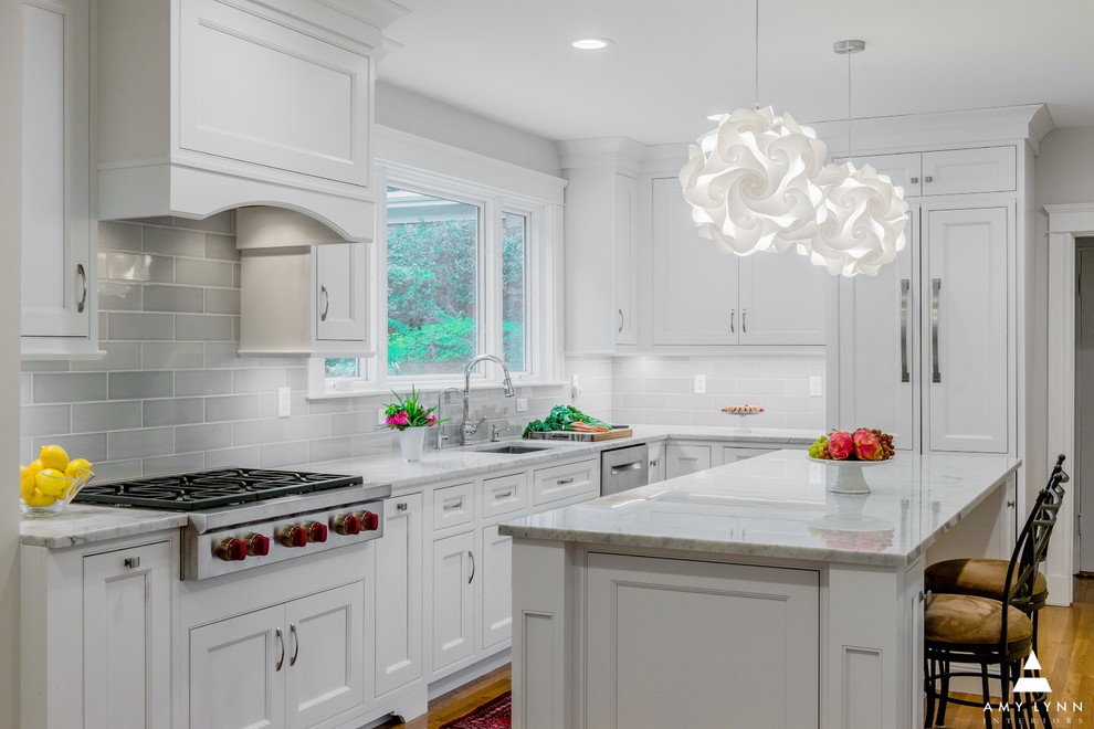 Inspiration for a mid-sized transitional l-shaped medium tone wood floor and red floor eat-in kitchen remodel in Boston with an undermount sink, beaded inset cabinets, white cabinets, marble countertops, gray backsplash, porcelain backsplash, paneled appliances, an island and yellow countertops