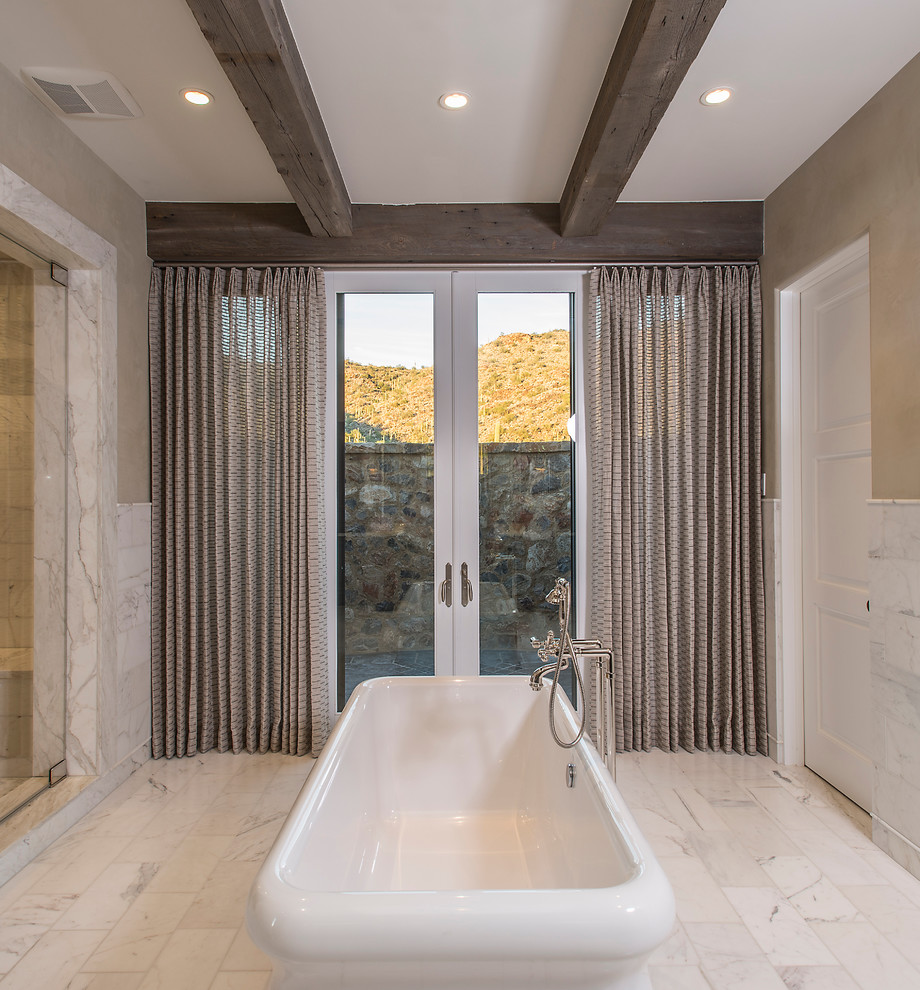 Inspiration for a large transitional master multicolored tile and stone tile marble floor freestanding bathtub remodel in Phoenix with beige walls