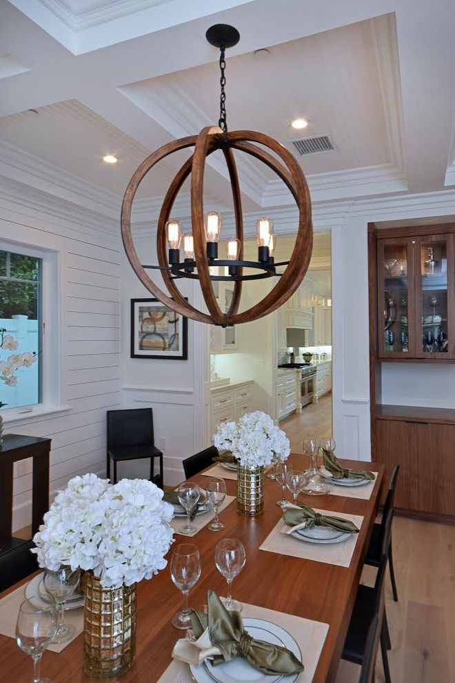 Enclosed dining room - transitional light wood floor and beige floor enclosed dining room idea with white walls