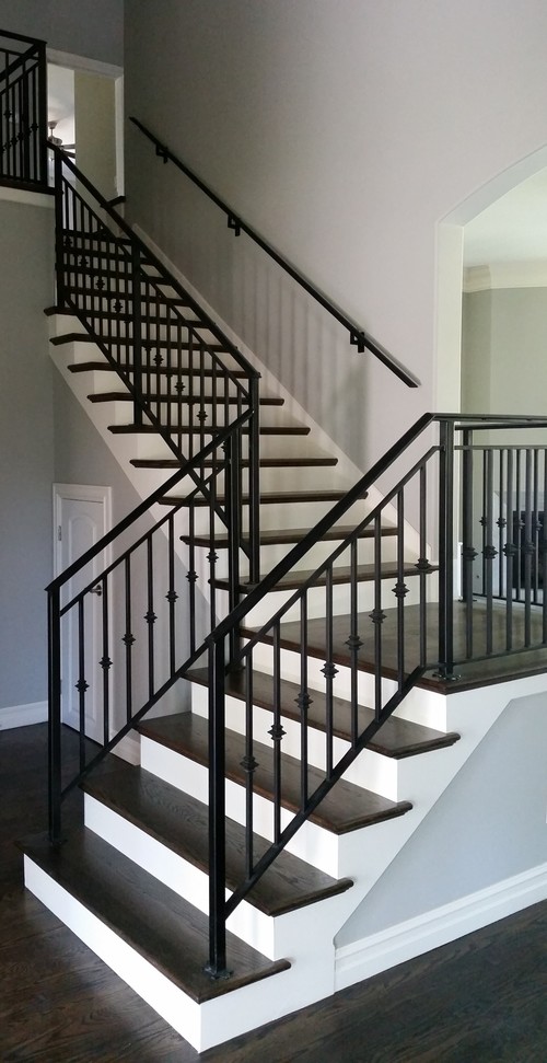 Photo of a mid-sized transitional wood l-shaped staircase in Oklahoma City with painted wood risers and metal railing.
