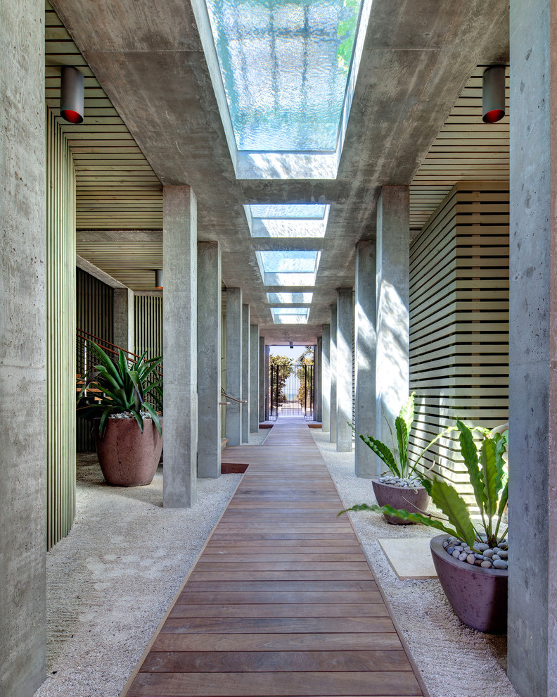 Inspiration for a mid-sized tropical courtyard driveway in Tampa with a garden path and natural stone pavers.