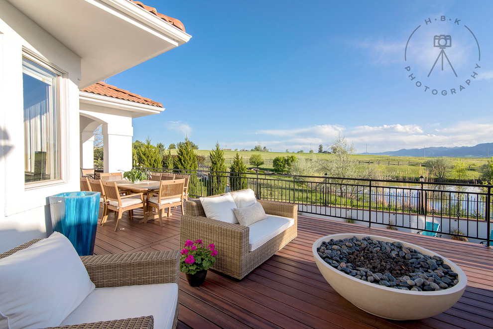 Patio - huge mediterranean backyard patio idea with a fire pit, decking and no cover
