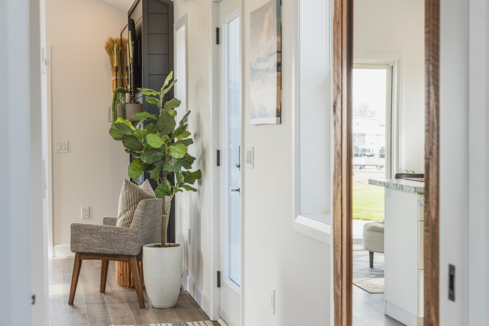 Источник вдохновения для домашнего уюта: маленький коридор в стиле модернизм с белыми стенами, полом из винила, коричневым полом и сводчатым потолком для на участке и в саду
