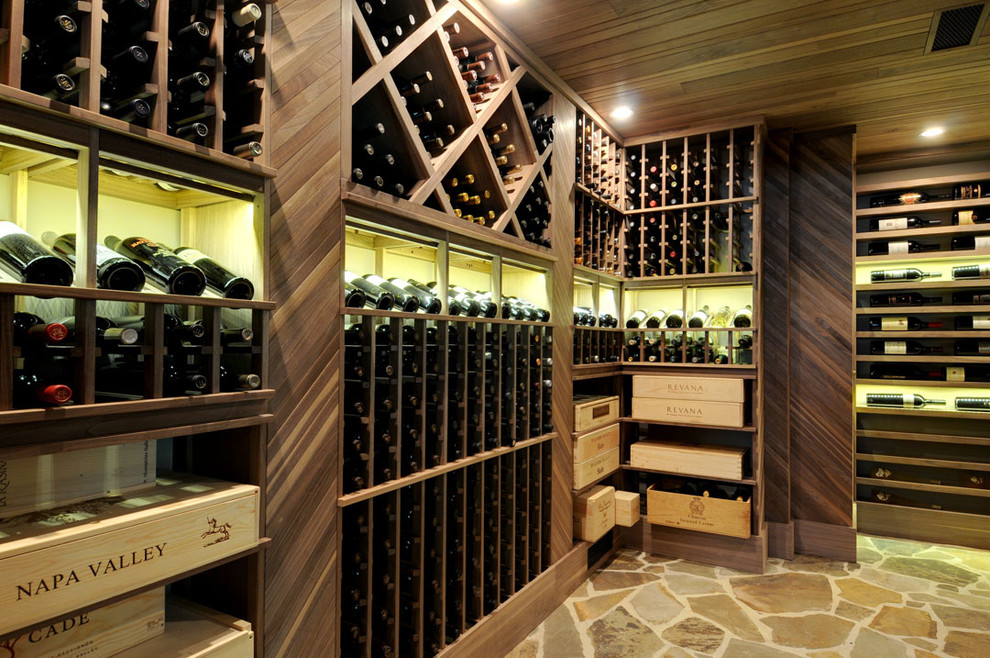 This is an example of a traditional wine cellar in Atlanta with storage racks and beige floor.