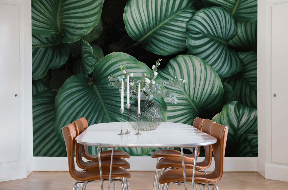 Inspiration for a transitional dining room in Gothenburg with green walls, light hardwood floors and beige floor.