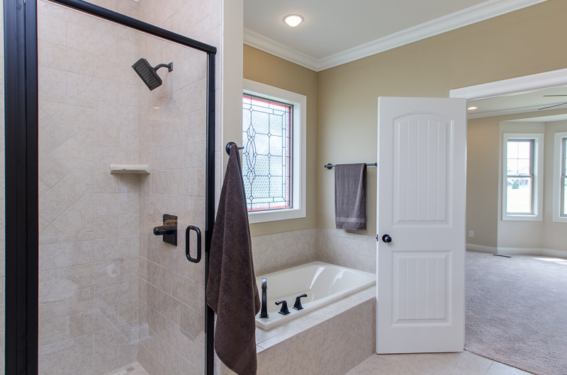 Example of a mid-sized transitional master ceramic tile ceramic tile drop-in bathtub design in Louisville with recessed-panel cabinets, dark wood cabinets, beige walls, an undermount sink and granite countertops