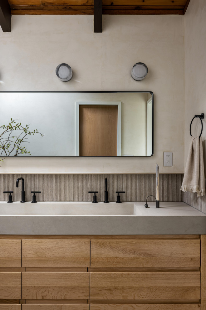 This is an example of a small transitional master bathroom in New York with flat-panel cabinets, light wood cabinets, an open shower, a one-piece toilet, beige walls, slate floors, an integrated sink, concrete benchtops, black floor, a shower curtain, grey benchtops, a double vanity, exposed beam and a built-in vanity.