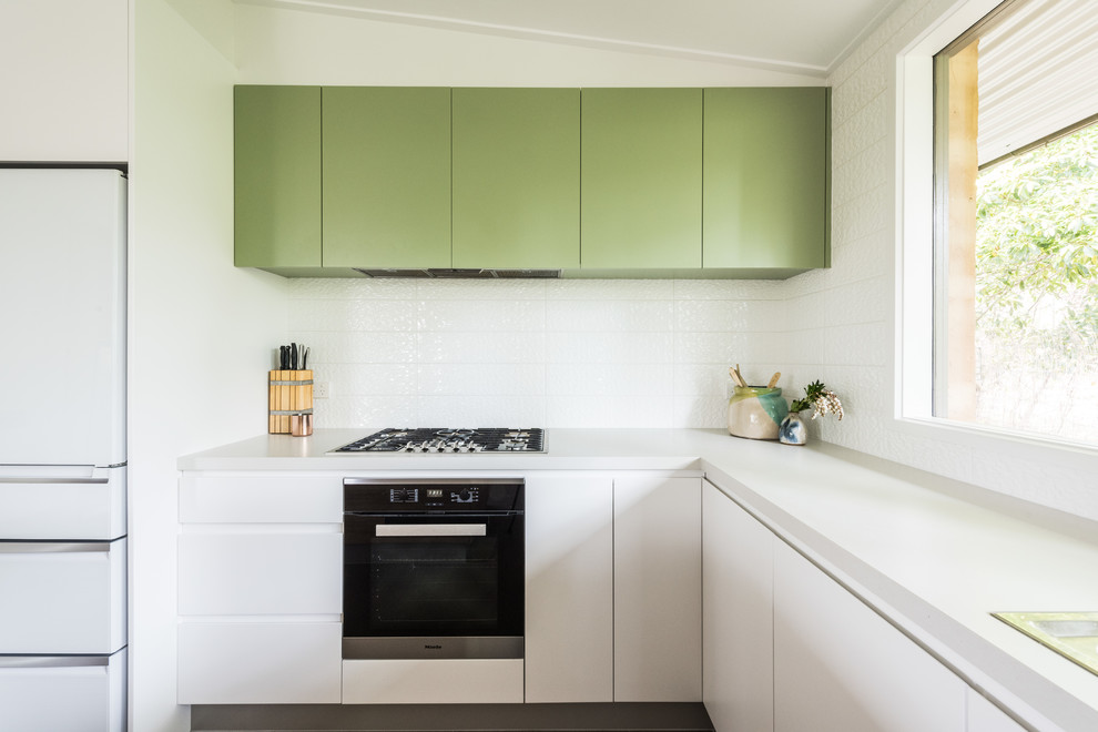 Design ideas for a mid-sized contemporary l-shaped kitchen in Melbourne with a double-bowl sink, light wood cabinets, quartz benchtops, white splashback, ceramic splashback, stainless steel appliances, porcelain floors, with island and grey floor.