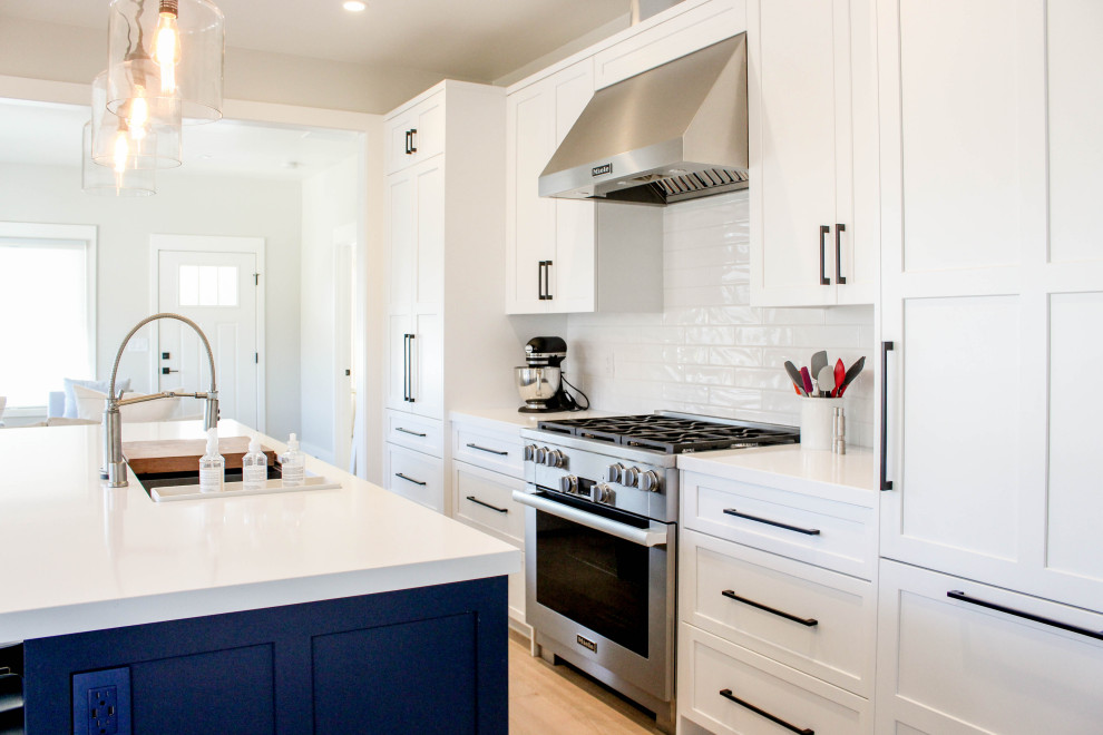 Inspiration for a transitional beige floor kitchen remodel with white backsplash, subway tile backsplash and white countertops