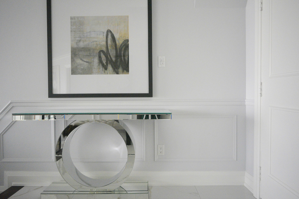 Example of a mid-sized transitional ceramic tile foyer design in Toronto with blue walls and a white front door