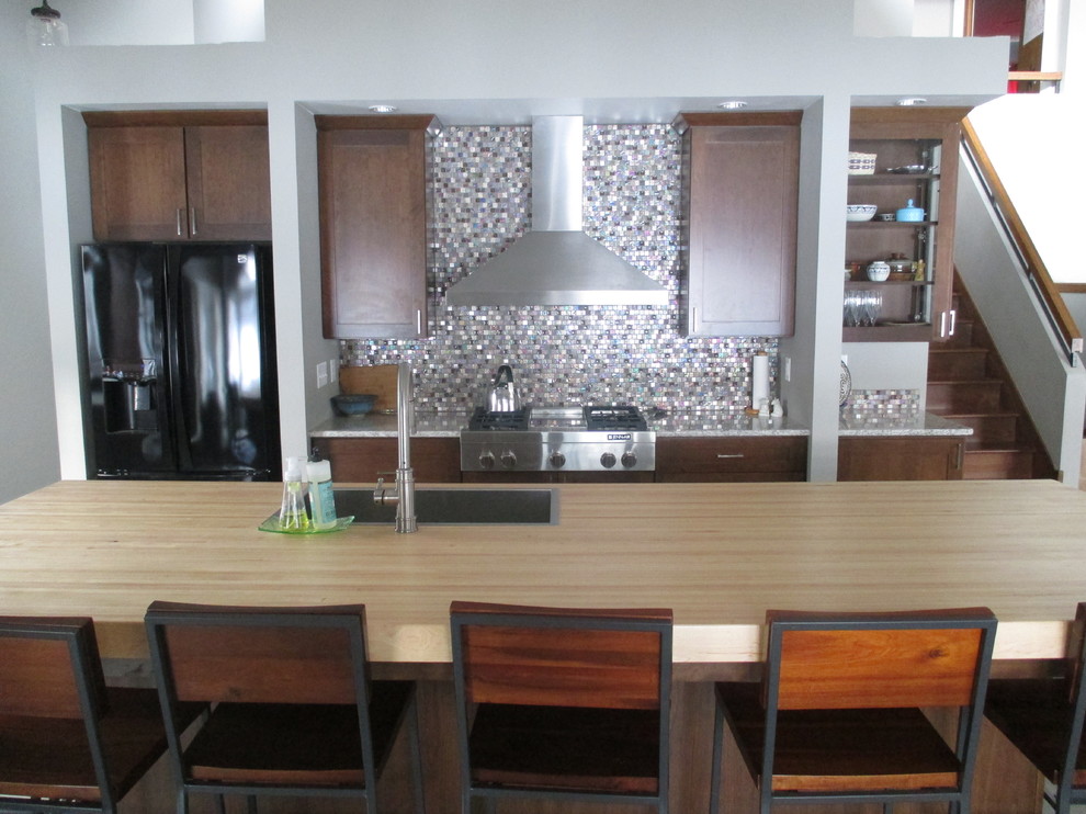 Inspiration for a mid-sized transitional galley ceramic tile eat-in kitchen remodel with a drop-in sink, shaker cabinets, dark wood cabinets, quartz countertops, stainless steel appliances, an island, metallic backsplash and mosaic tile backsplash