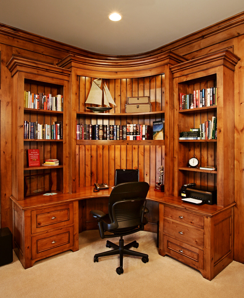 Large traditional study room in Grand Rapids with carpet and a built-in desk.