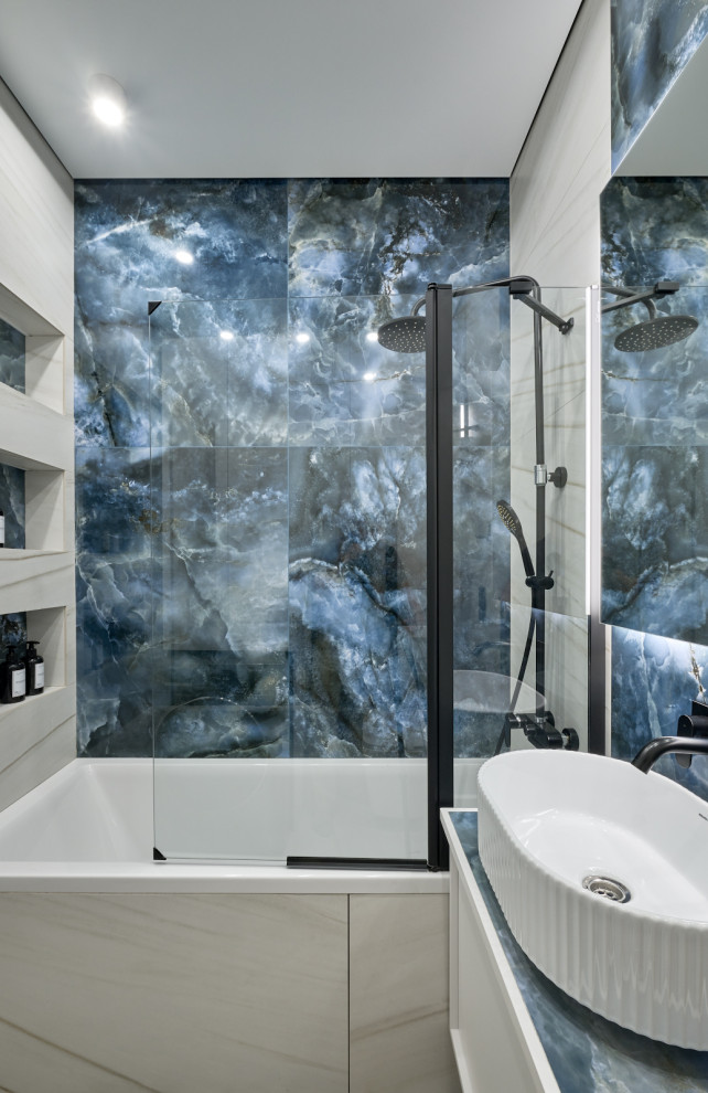 Inspiration for a mid-sized contemporary master bathroom in Moscow with raised-panel cabinets, white cabinets, an undermount tub, a shower/bathtub combo, a wall-mount toilet, blue tile, white tile, porcelain tile, blue walls, ceramic floors, a vessel sink, tile benchtops, white floor, a hinged shower door, blue benchtops, a single vanity and a floating vanity.