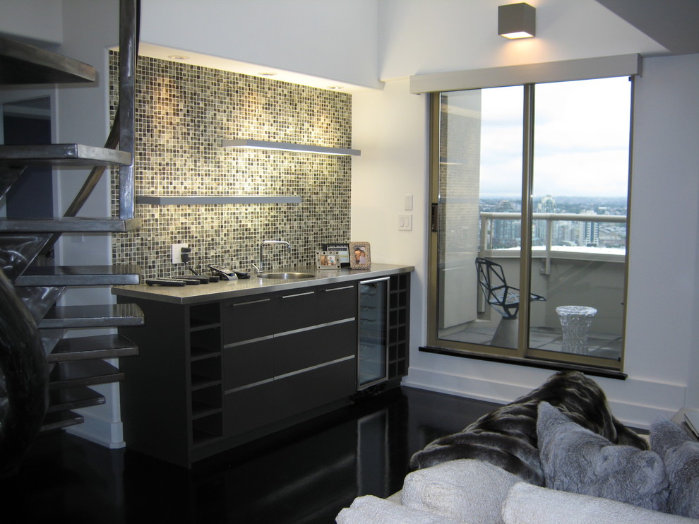 This is an example of a small contemporary single-wall wet bar in Vancouver with an integrated sink, flat-panel cabinets, dark wood cabinets, stainless steel benchtops, multi-coloured splashback, mosaic tile splashback and dark hardwood floors.