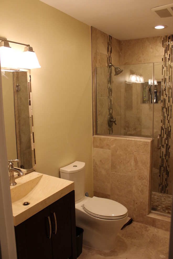 This is an example of a mid-sized transitional master bathroom in DC Metro with an alcove shower, a two-piece toilet, brown tile, stone tile, beige walls and marble floors.