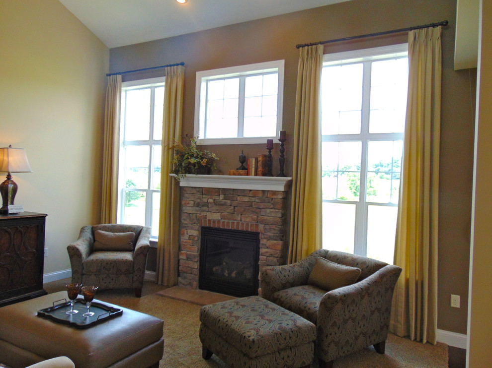 This is an example of a mid-sized traditional open concept family room in Philadelphia with beige walls, carpet, a standard fireplace, a stone fireplace surround and beige floor.