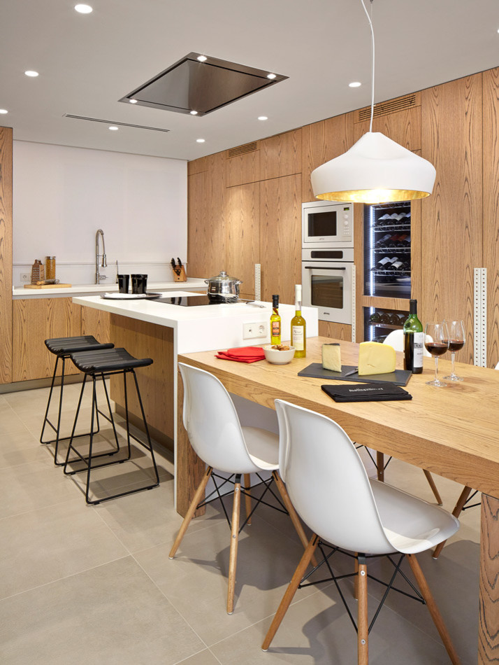 Design ideas for a mid-sized contemporary single-wall open plan kitchen in Barcelona with flat-panel cabinets, medium wood cabinets and with island.