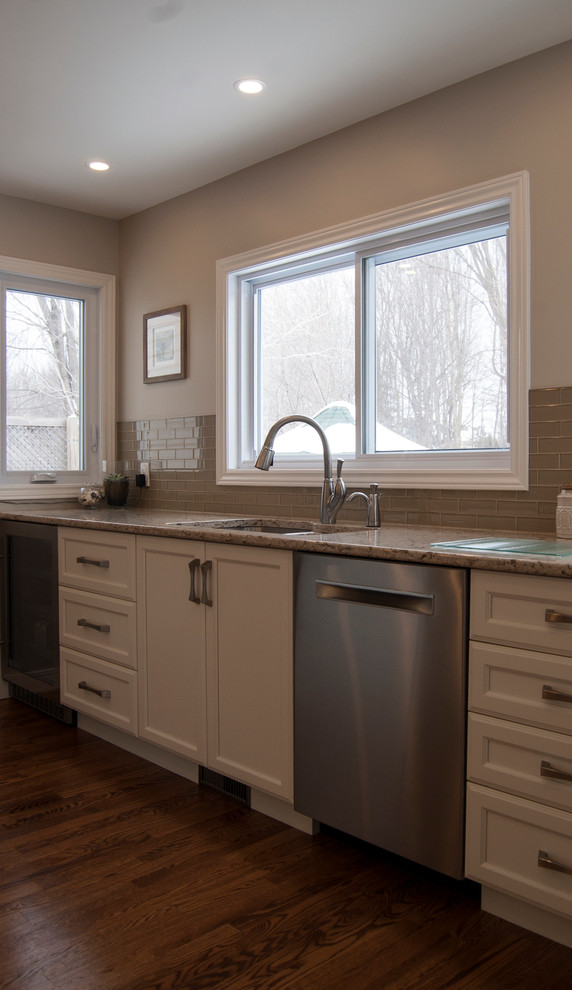 Example of a transitional kitchen design in Ottawa with an island