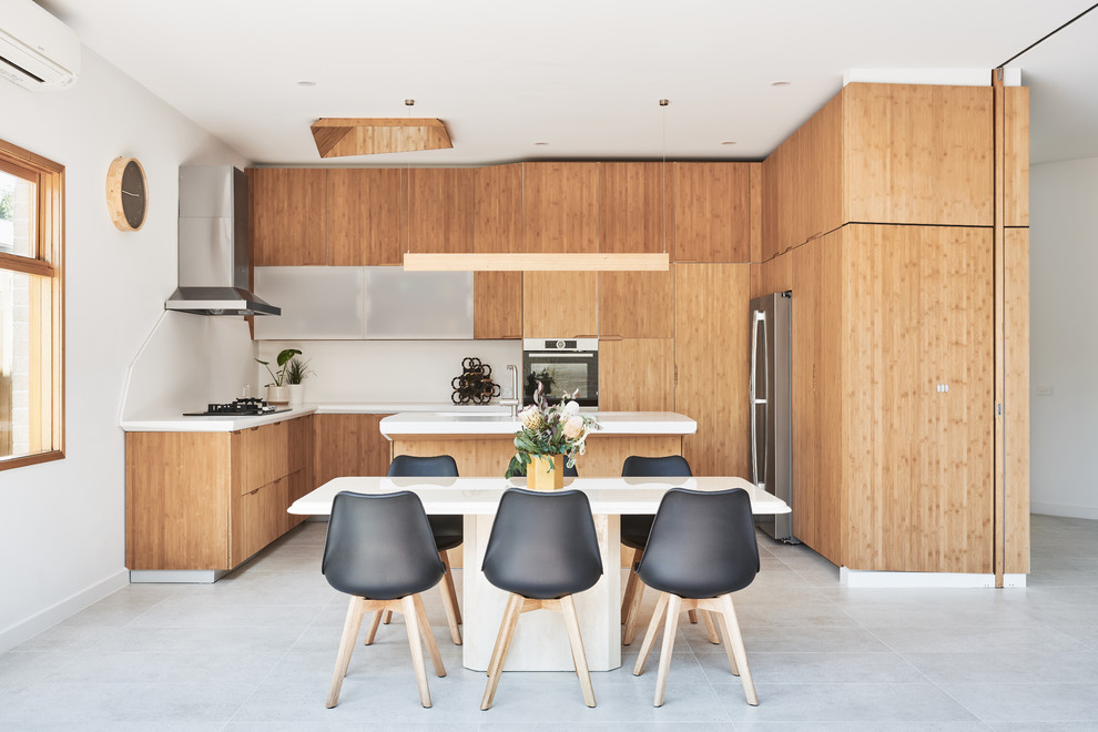 This is an example of a contemporary open plan dining in Melbourne with white walls and grey floor.