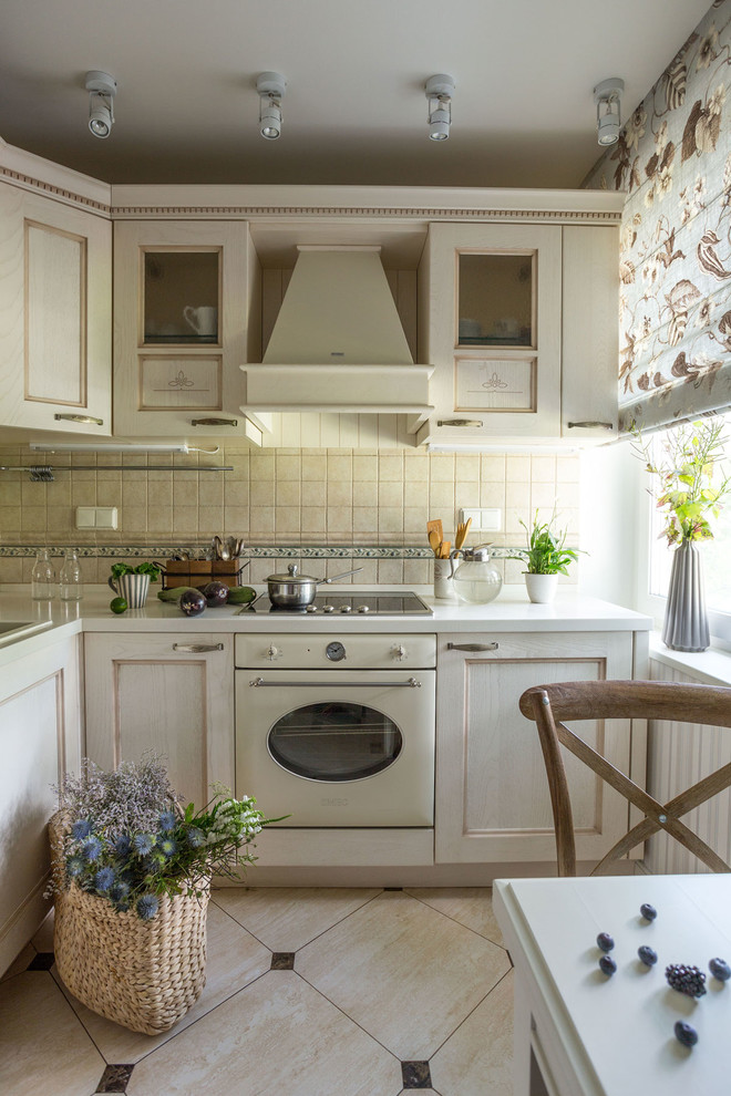 Inspiration for a traditional l-shaped separate kitchen in Moscow with a drop-in sink, recessed-panel cabinets, white cabinets, beige splashback, white appliances and no island.