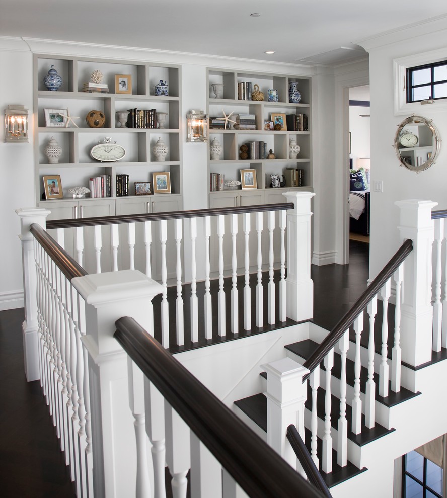 Design ideas for a beach style wood l-shaped staircase in San Diego with painted wood risers.