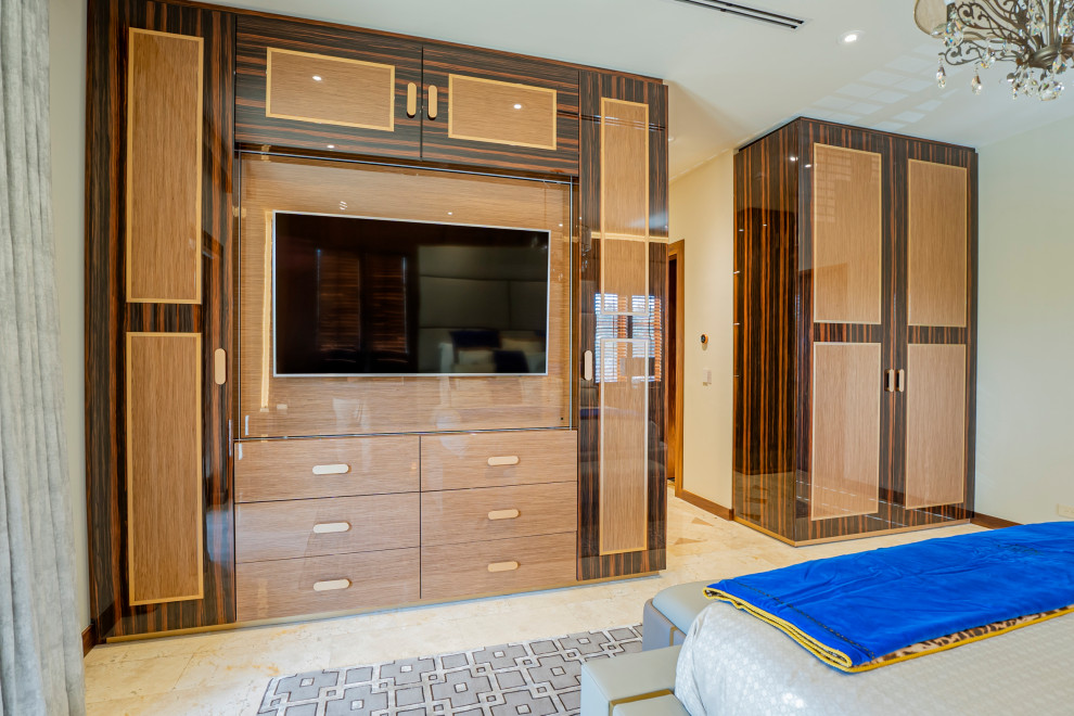 Design ideas for a contemporary storage and wardrobe in Miami with medium hardwood floors.