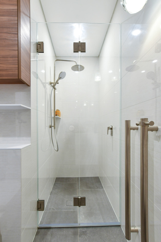 Inspiration for a small contemporary master bathroom in Sydney with medium wood cabinets, an alcove shower, white walls, an integrated sink, solid surface benchtops, grey floor, a hinged shower door and white benchtops.